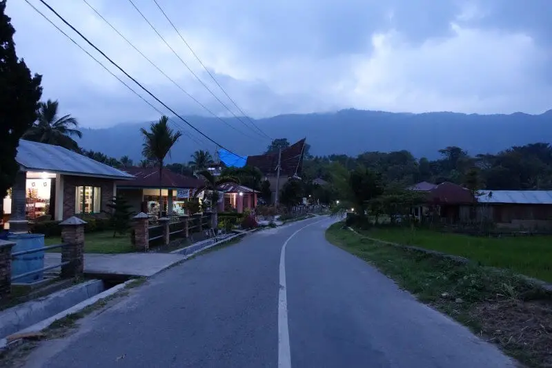 Mountains rising behind the villages. Lake Toba, Indonesia.