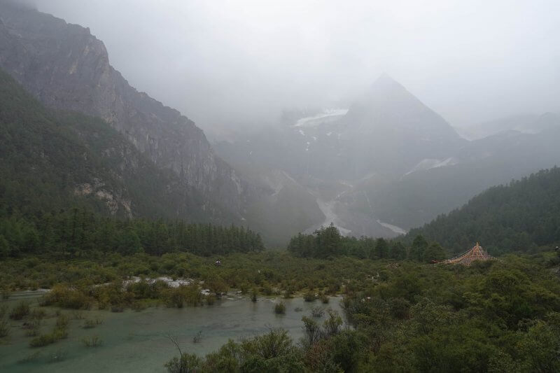 Emerging from the forests into the rain. Yading Nature Reserve, Sichuan.