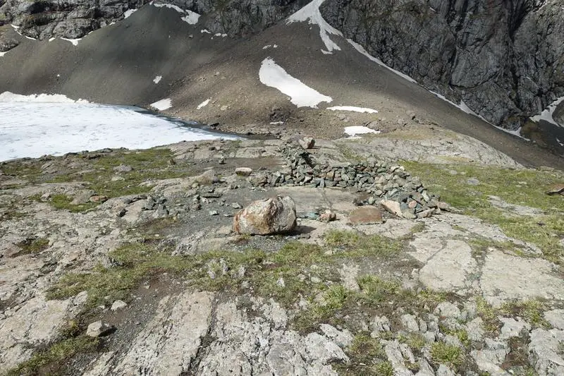 Rock walls to keep the wind from tents at night. Ala-Kul, Kyrgyzstan.